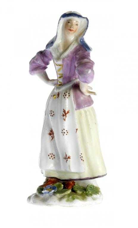 Appraisal: A MEISSEN MINIATURE FIGURE OF A LADY on sprigged green