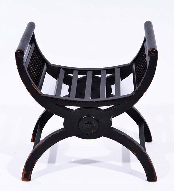 Appraisal: AN EBONISED DRESSING STOOL with slat sides and inverted supports