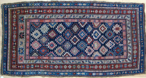 Appraisal: Caucasian rug ca with repeating geometric designs on a navy