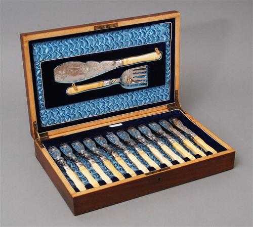 Appraisal: FISH UTENSILS Silver-plated th century Ivory handles with carved beading