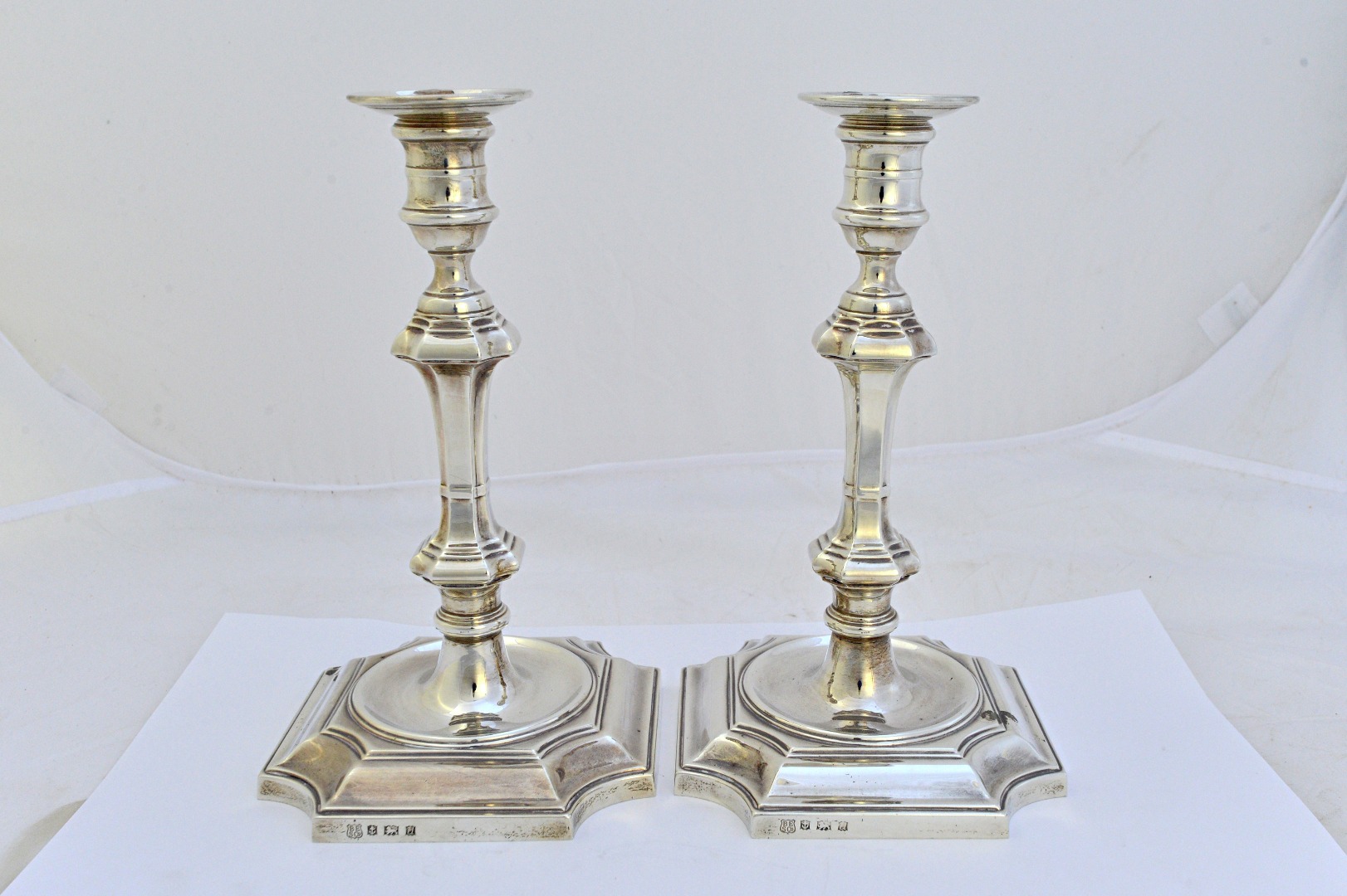 Appraisal: A pair of silver table candlesticks each with a tapered