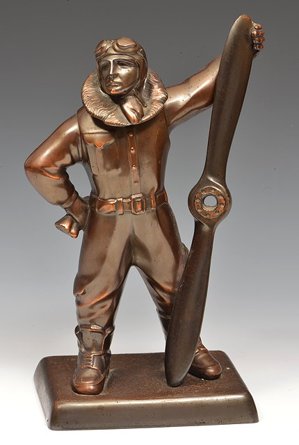 Appraisal: A BRONZED SPELTER NOVELTY CIGARETTE LIGHTER in the form of