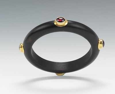 Appraisal: A Carved Mahogany Bangle Bracelet with Garnet Cabochons Carved wood