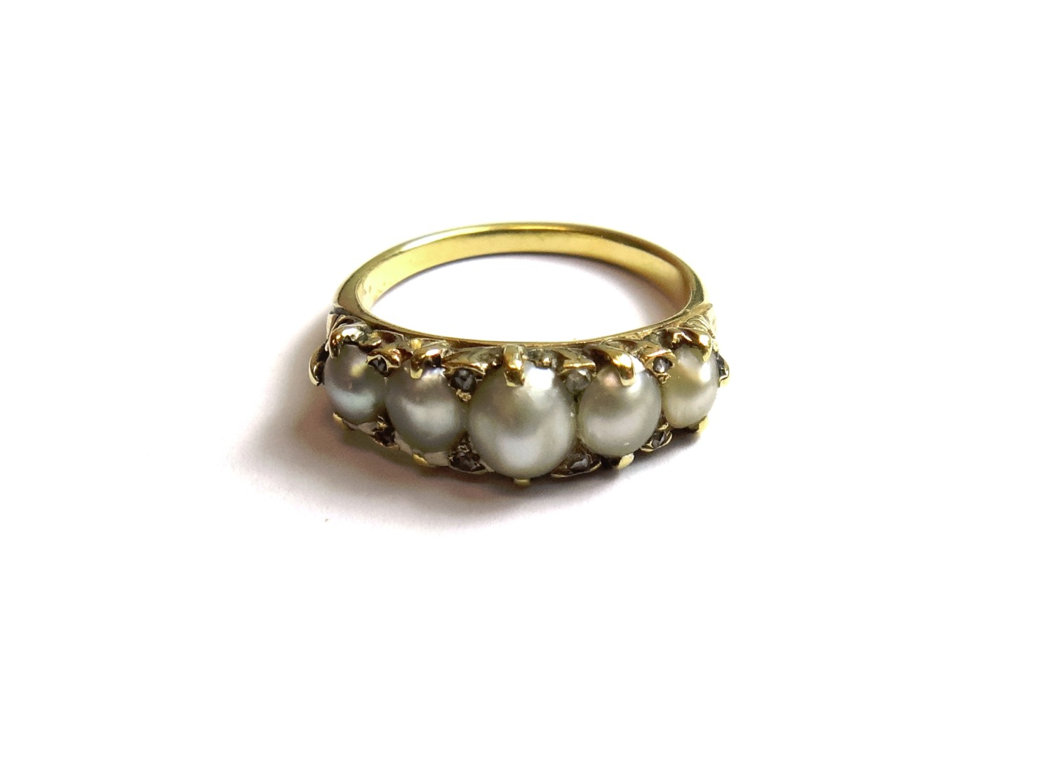 Appraisal: A gold ring mounted with a row of five graduated