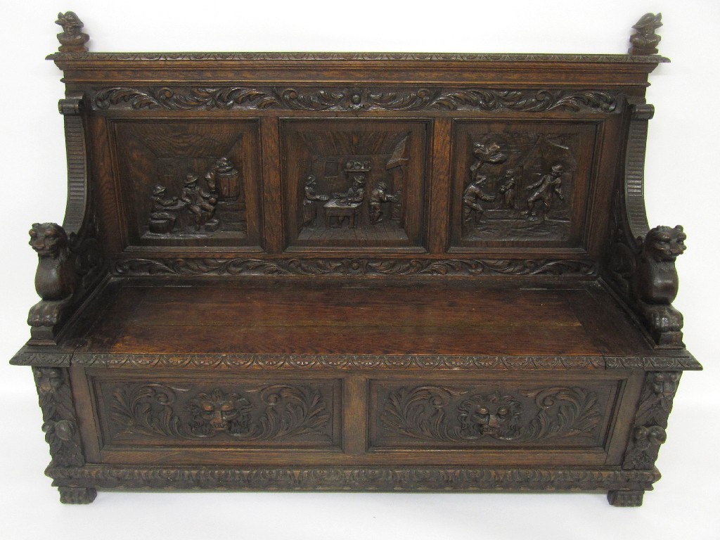 Appraisal: A carved oak hall settle the top decorated with a