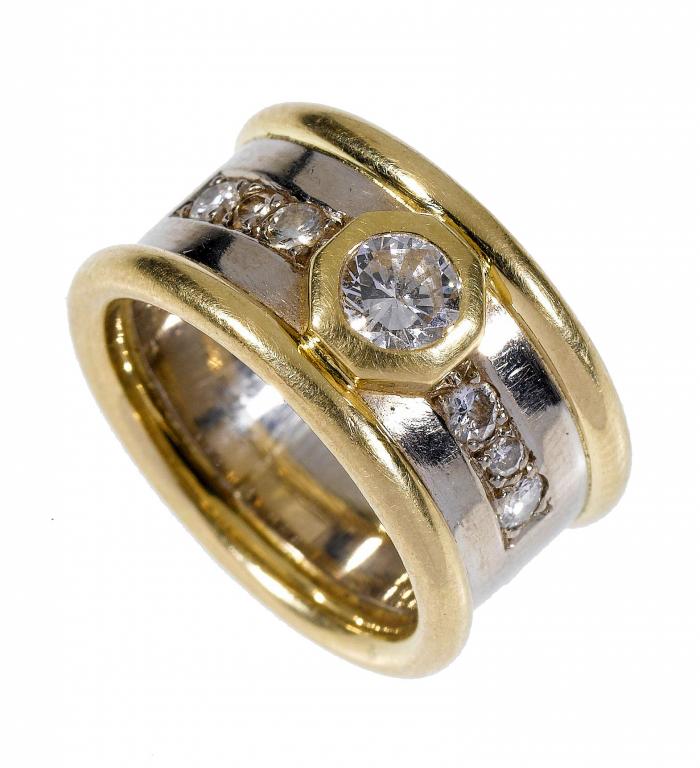 Appraisal: A DIAMOND RING the larger collet flanked by lines of