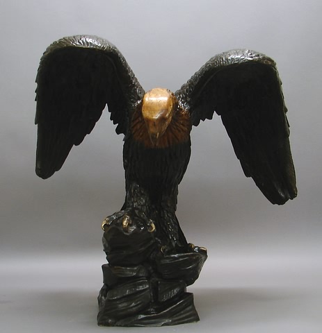 Appraisal: Spread-wing eagle on rocky base brown patina with gold patina