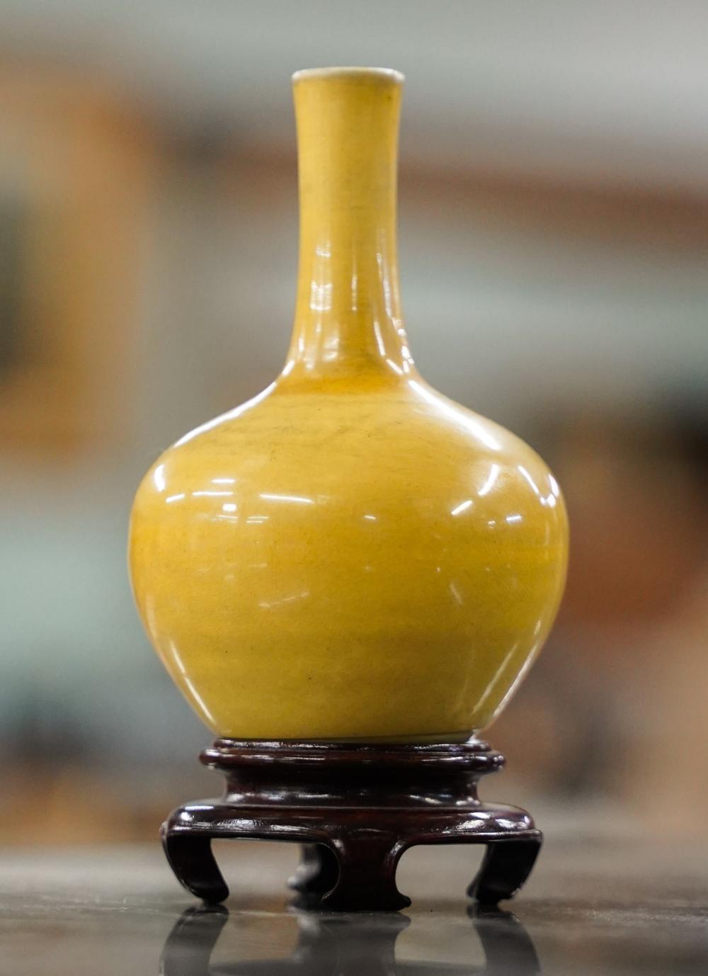 Appraisal: CHINESE YELLOW-GLAZED PORCELAIN VASE ON WOOD STANDunsigned Dimensions in cm