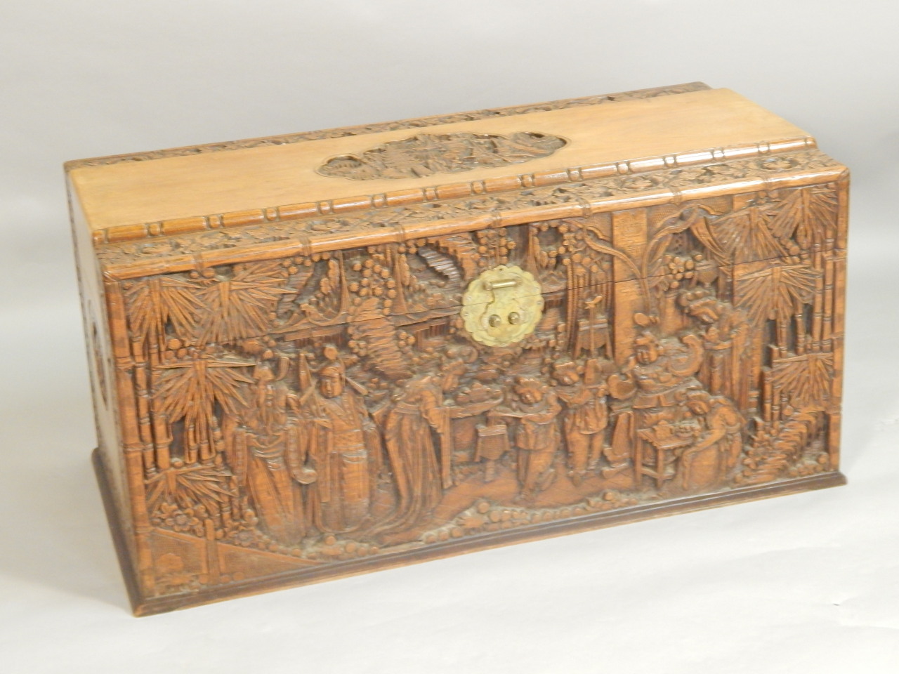 Appraisal: A mid thC extensively carved Chinese camphorwood chest decorated overall