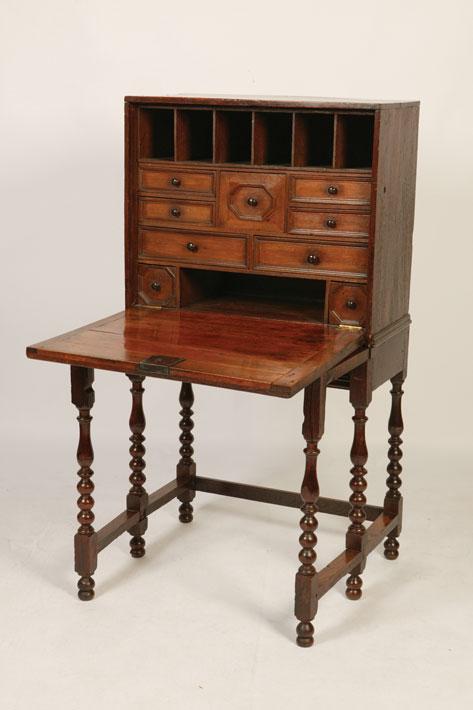 Appraisal: A CHARLES II OAK CABINET ON STAND with a panelled