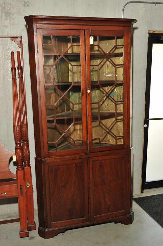 Appraisal: TWO PIECE CORNER CUPBOARD Walnut having a thumb molded cornice