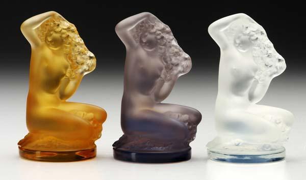 Appraisal: LALIQUE Three Floreal statuettes in opalescent purple and amber glass