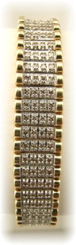 Appraisal: K two-tone gold line bracelet with bead set round diamonds