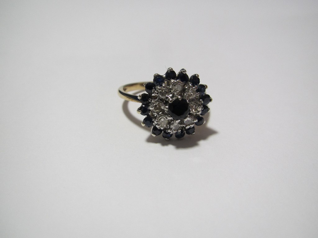 Appraisal: A ladies diamond and sapphire cluster ring of circular target