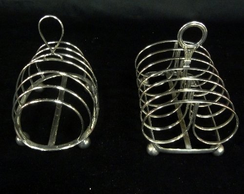 Appraisal: Two seven-bar plated toast racks on ball feet cm wide