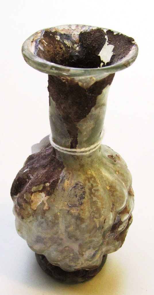 Appraisal: A Roman green glass head flask mould-blown with a male