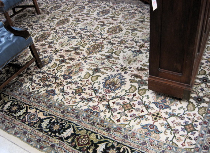 Appraisal: HAND KNOTTED ORIENTAL CARPET Indo-Persian featuring a flower decorated rectangular