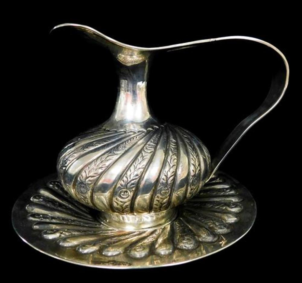 Appraisal: SILVER ' ' silver repousse pitcher on round liner flared