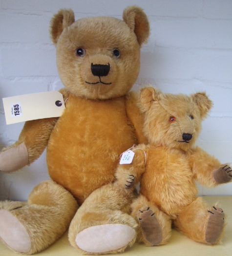 Appraisal: Two 's 'Chilterns' golden haired teddy bears one with growler