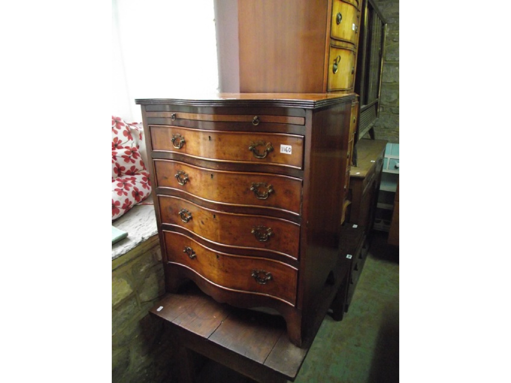 Appraisal: A good quality reproduction walnut veneered serpentine front bachelors type