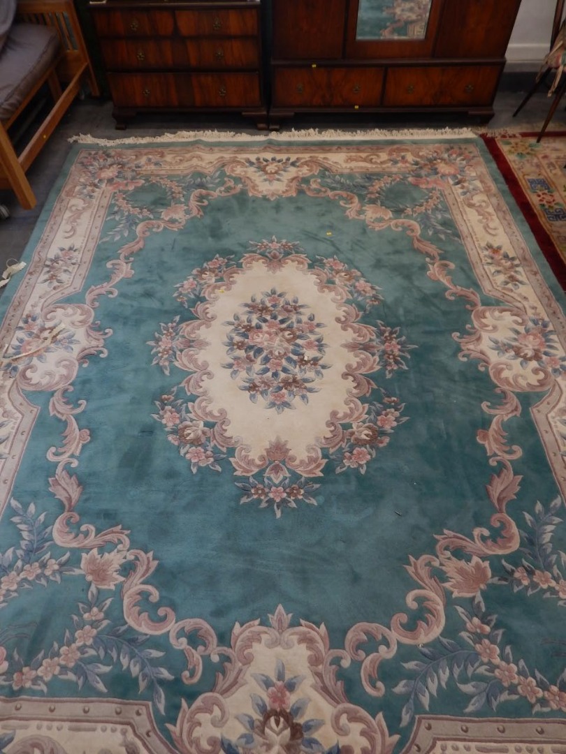 Appraisal: A large Chinese cut wool carpet decorated with flowers and