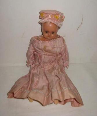 Appraisal: A wax over composition shoulder head doll with olive green