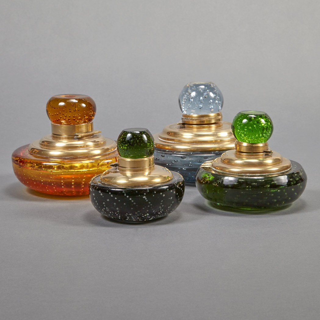 Appraisal: Four Brass Mounted Colored Glass Inkwells Each of circular form