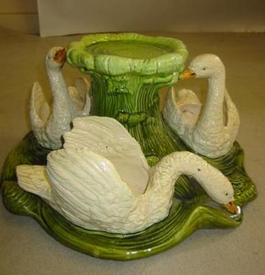 Appraisal: A BRETBY MAJOLICA JARDINIERE modelled as three swan plant holders