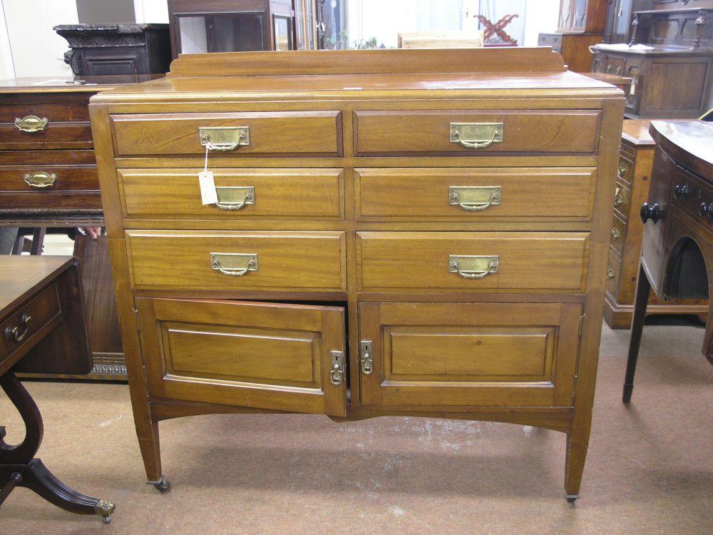 Appraisal: A mahogany bedroom chest six short drawers above panelled cupboard