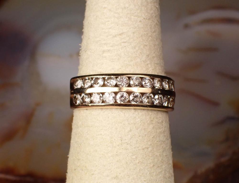 Appraisal: DIAMOND AND FOURTEEN KARAT YELLOW GOLD BAND channel set with