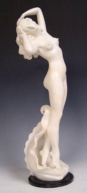 Appraisal: FEMALE NUDE MARBLE SCULPTURE ON WAVE CREST Probably Italian ''