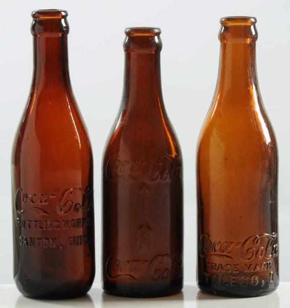 Appraisal: Lot of Coca-Cola Amber Straight-Sided Bottles From Ohio Toledo Canton