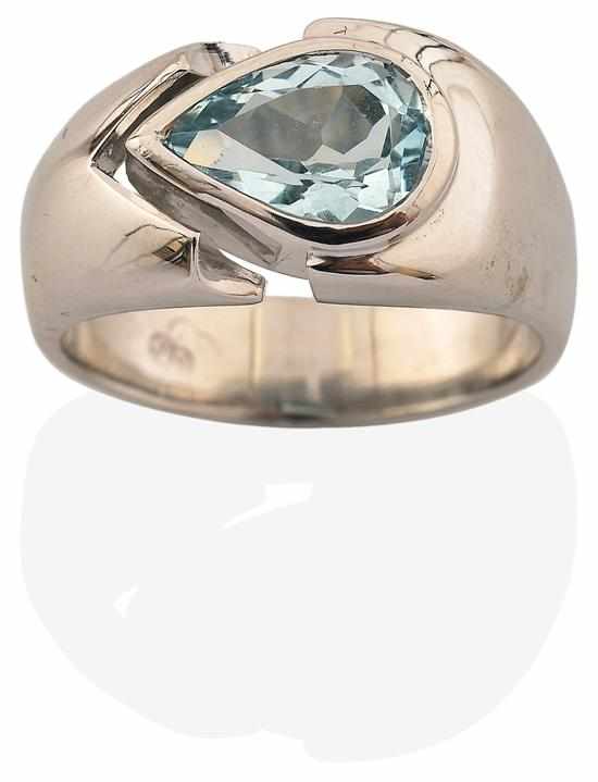 Appraisal: AN AQUAMARINE RING The modernist setting with pear cut aquamarine