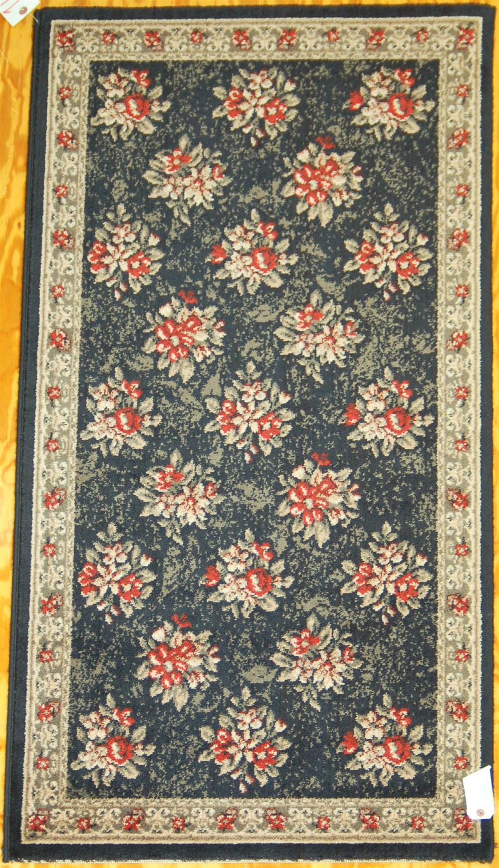 Appraisal: TWO MACHINE MADE SYNTHETIC RUGS first is of a floral