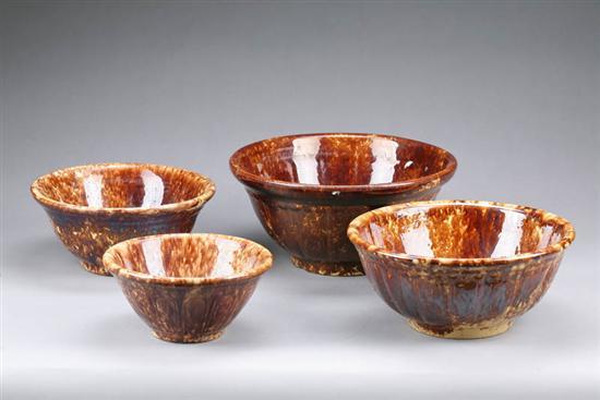 Appraisal: FOUR ROCKINGHAM BOWLS All with similar panel and swag molded