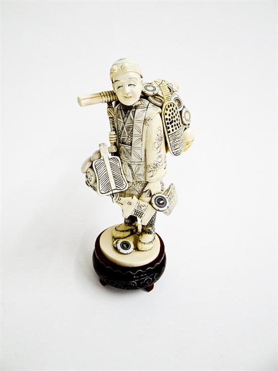 Appraisal: CARVED IVORY PEDDLER Japan st half- th century Man carrying