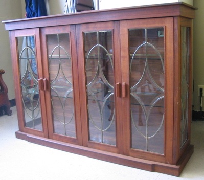 Appraisal: A CUSTOM CRAFTED WALNUT AND LEADED GLASS CURIO DISPLAY CABINET