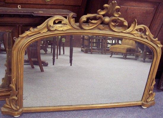 Appraisal: A gilded overmantel with pierced C scroll and acanthus surmount