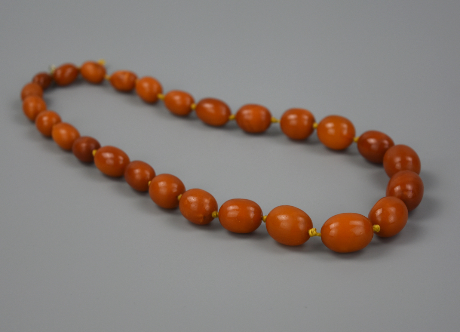 Appraisal: A CHINESE BEED BEESWAX NECKLACE A necklace of polished beeswax