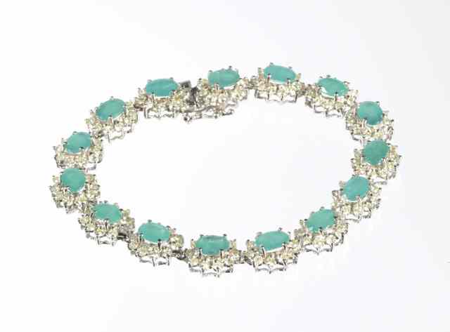 Appraisal: EMERALD AND DIAMOND BRACELET k white gold with oval-cut green