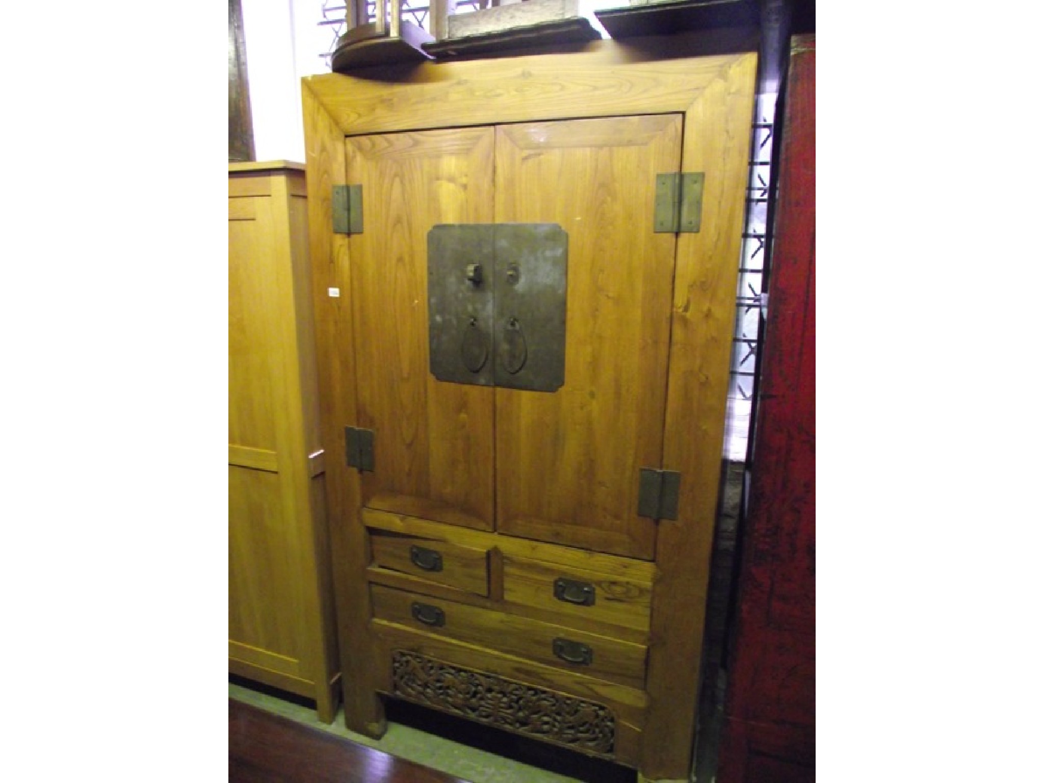 Appraisal: A substantial Chinese elm wardrobe side cupboard partially enclosed by