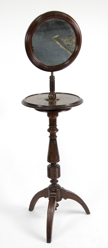 Appraisal: A Victorian mahogany shaving stand with circular adjustable mirror on