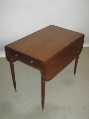 Appraisal: A MAHOGANY PEMBROKE TABLE of rounded oblong form with stringing