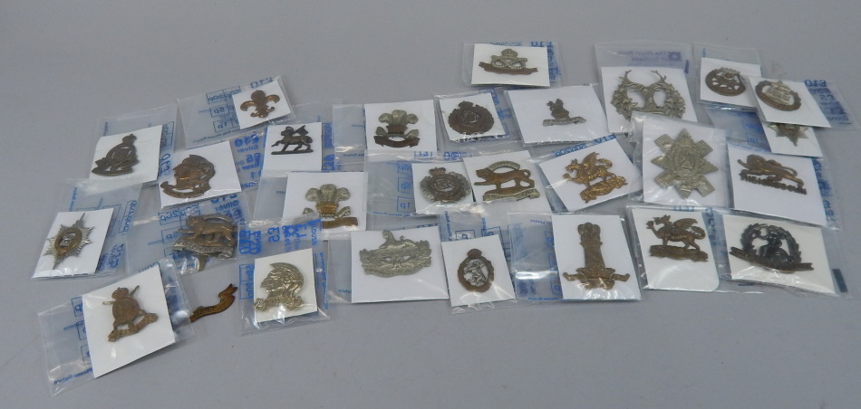 Appraisal: A quantity of military cap badges to include The Gloucestershire