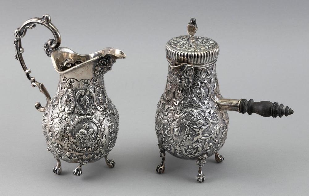 Appraisal: ORNATE REPOUSSE SILVER CHOCOLATE POT AND CREAM PITCHER THE NETHERLANDS