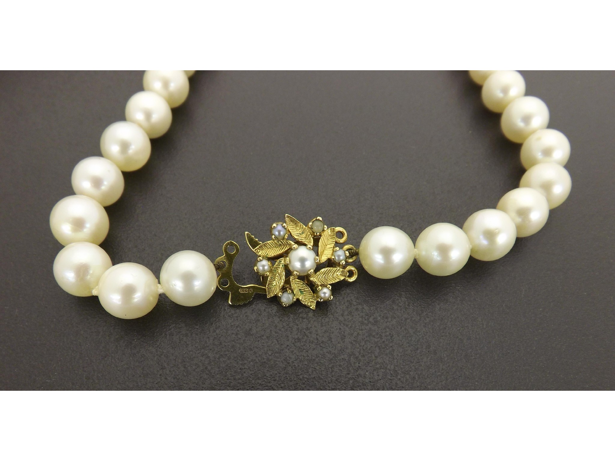 Appraisal: String of cultured pearls with a ct clasp pearls -