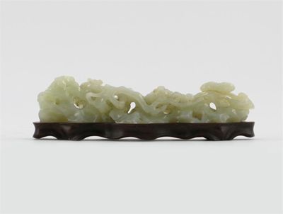 Appraisal: A Chinese pale celadon jade brush rest carved as flowering