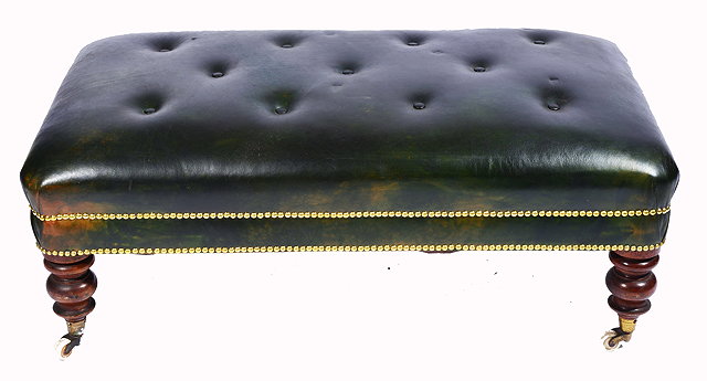 Appraisal: A GREEN LEATHER BUTTON UPHOLSTERED RECTANGULAR LOW STOOL with studded