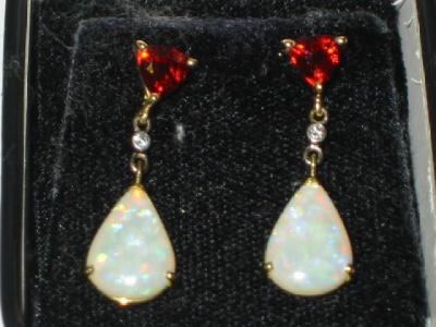 Appraisal: A PAIR OF GARNET AND OPAL EARRINGS the triangular cut