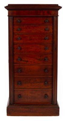 Appraisal: A mahogany Wellington chest with cushion top fitted eight drawers